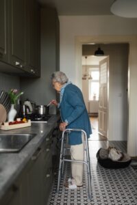 A senior woman enjoying her kitchen with aging-in-place modifications.