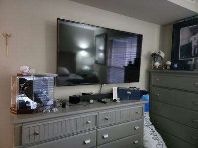 A TV mounted securely on a wall.