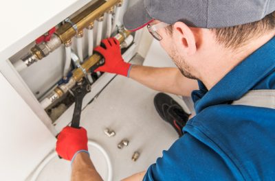 Plumbing repairs to fix a leaky pipe in the wall.